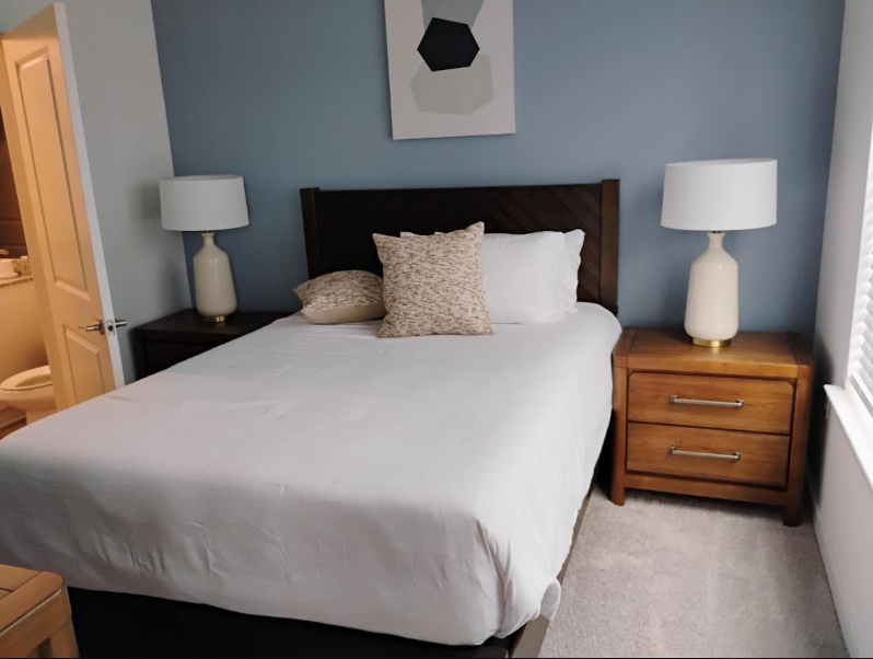 Freshly made bedroom with crisp linens and organized nightstands