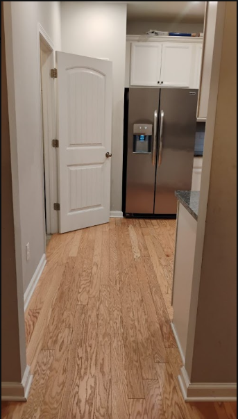 Freshly cleaned hallway with gleaming hardwood floors