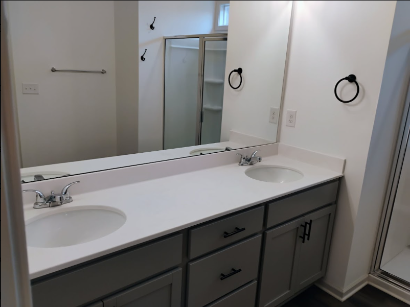 Clean double-vanity bathroom with polished mirror