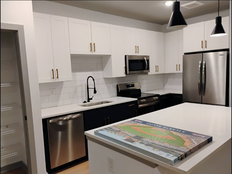 Modern white kitchen with stainless appliances after deep clean