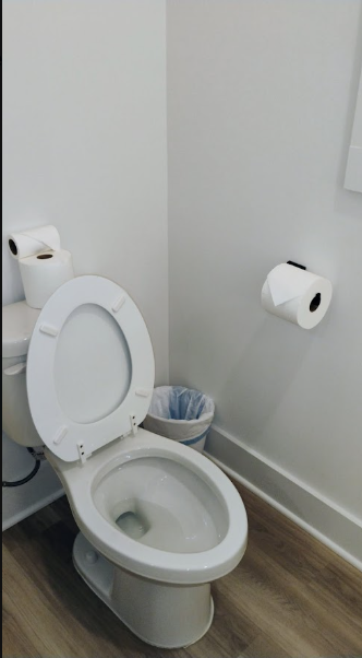 Sanitized powder room with pristine toilet and floors