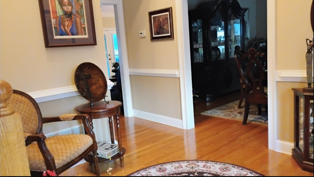 Elegant foyer and formal dining room with polished hardwood floors