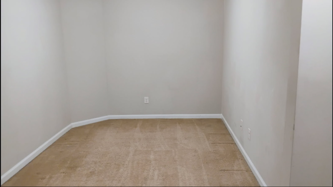 Freshly vacuumed carpeted bedroom with visible cleaning lines