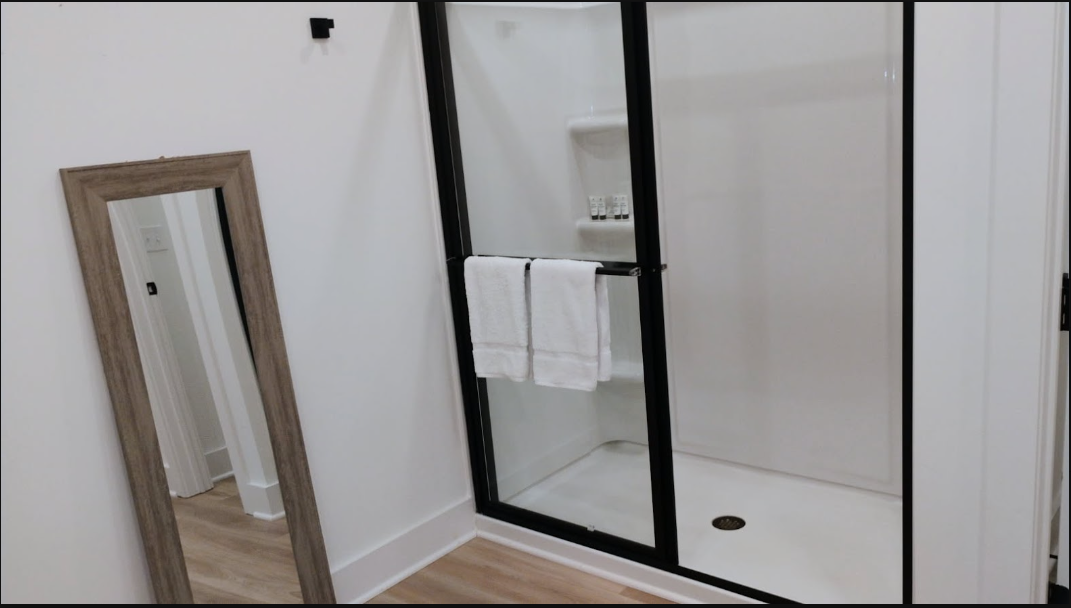 Spa-style walk-in shower with folded towels
