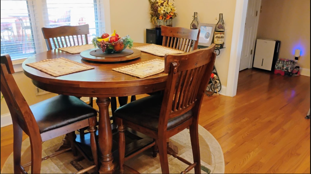 Breakfast nook with round wood table set and swept floors