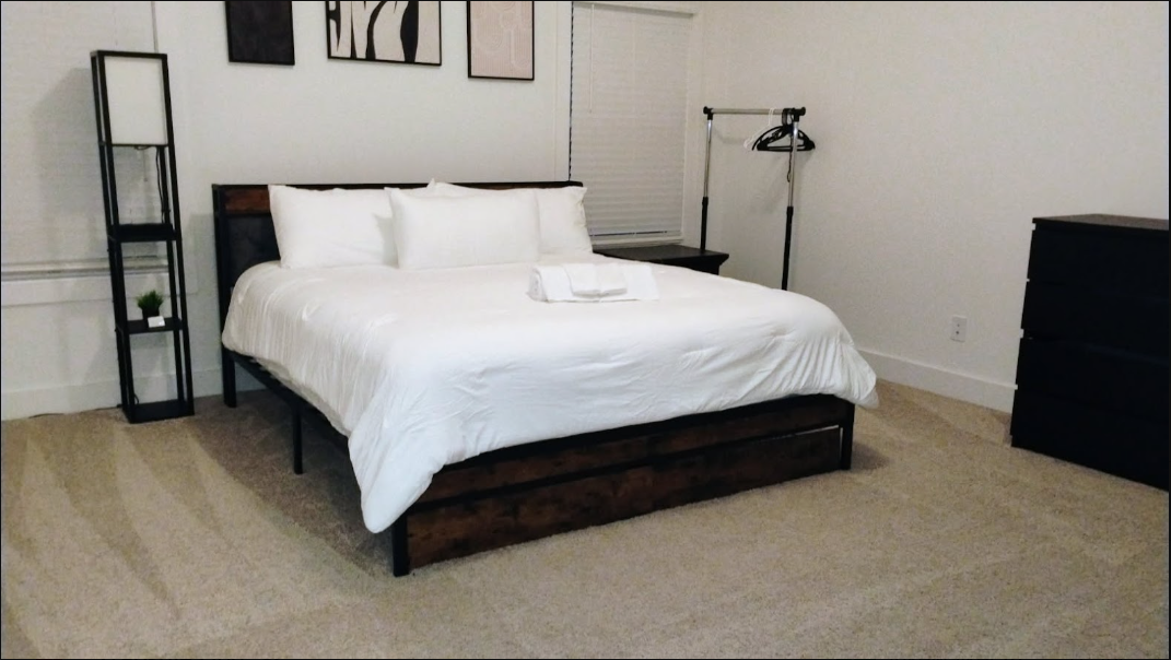 Neatly made bedroom with organized furniture