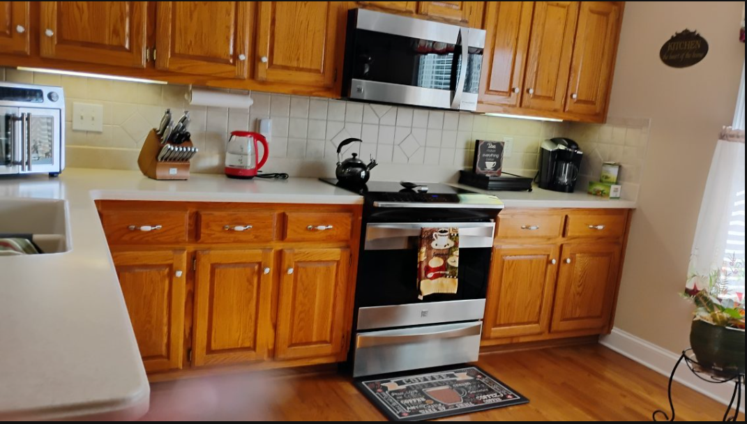 Warm oak kitchen with detailed appliance and counter cleaning